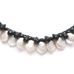 Chocolate leather, white coin pearls, faceted jet crystal, obsidian and silver beads.[382]